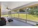 Relaxing screened porch with seating and backyard view at 4980 Sw 195Th Ave, Dunnellon, FL 34431