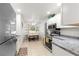 Modern kitchen with white cabinets, granite countertops, and stainless steel appliances at 4980 Sw 195Th Ave, Dunnellon, FL 34431