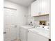 Laundry room with washer, dryer, and overhead cabinets at 4980 Sw 195Th Ave, Dunnellon, FL 34431
