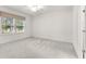 Bright bedroom with carpet flooring, neutral walls, and two windows at 7867 Sw 74Th Loop, Ocala, FL 34481