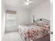 Bedroom with carpeted floor and floral bedding on a metal bed frame at 7867 Sw 74Th Loop, Ocala, FL 34481