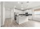 Modern kitchen with white cabinets, island, and stainless steel appliances at 7867 Sw 74Th Loop, Ocala, FL 34481