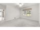 Spacious bedroom with carpet flooring, ceiling fan, and large windows at 7867 Sw 74Th Loop, Ocala, FL 34481