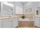 Spacious bathroom with double sinks, corner bathtub, and a separate shower at 12333 Se 177Th Loop, Summerfield, FL 34491