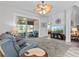 Spacious living room with sliding glass doors leading to a relaxing lanai at 12333 Se 177Th Loop, Summerfield, FL 34491