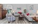 Relaxing living room with hardwood floors, comfortable seating, and access to patio at 12333 Se 177Th Loop, Summerfield, FL 34491
