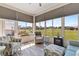 Sunroom with seating area and view of the golf course at 12333 Se 177Th Loop, Summerfield, FL 34491