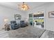 Relaxing Gathering room with two blue leather recliners and view to screened porch at 12333 Se 177Th Loop, Summerfield, FL 34491