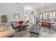 Open concept living room with hardwood floors, neutral decor, and dining area view at 12333 Se 177Th Loop, Summerfield, FL 34491