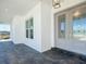 Modern farmhouse front entry with gray double doors and sidelights at 6530 Se 156Th Loop # 3 & 4, Summerfield, FL 34491