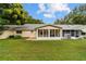 Back of house with screened patio, AC unit and grassy yard at 9357 Sw 82Nd Ter # B, Ocala, FL 34481