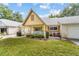 Inviting yellow house with a porch and lush green landscaping at 9357 Sw 82Nd Ter # B, Ocala, FL 34481