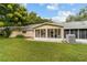 Back of house with screened patio, AC unit and grassy yard at 9357 Sw 82Nd Ter # B, Ocala, FL 34481