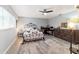 Bright bedroom with a metal bed frame, dresser, and workspace at 9357 Sw 82Nd Ter # B, Ocala, FL 34481
