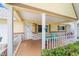 Charming front porch with white columns and teal chairs at 9357 Sw 82Nd Ter # B, Ocala, FL 34481