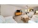 Bright living room with comfy seating, large TV, and fireplace at 9357 Sw 82Nd Ter # B, Ocala, FL 34481