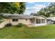Spacious backyard featuring a screened patio and green space at 9357 Sw 82Nd Ter # B, Ocala, FL 34481