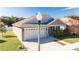 One story home with gray siding, white garage door, and a lamp post in front at 4763 Se 25Th Loop, Ocala, FL 34480