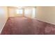 Large living room with neutral carpeting and ceiling fan at 8530 Sw 90Th St # E, Ocala, FL 34481