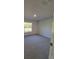 Spacious bedroom with neutral carpeting and large window at 7576 Sw 102Nd Loop, Ocala, FL 34476