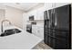 Modern kitchen with stainless steel appliances and a large island with seating at 706 Stanley Ave, Wildwood, FL 34785