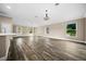 Spacious living room with wood-look flooring and a chandelier at 706 Stanley Ave, Wildwood, FL 34785
