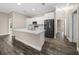 Modern kitchen featuring white shaker cabinets, quartz countertops, and stainless steel appliances at 706 Stanley Ave, Wildwood, FL 34785