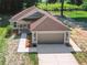 New single-Gathering home with a two-car garage and landscaped yard at 706 Stanley Ave, Wildwood, FL 34785