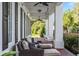 Relaxing front porch with wicker furniture, swing, and brick flooring at 22422 Lake Seneca Rd, Eustis, FL 32736