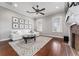 Gathering room with white couch, wood floors, and fireplace at 22422 Lake Seneca Rd, Eustis, FL 32736
