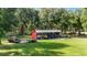 Open-air equipment shed with tractors and other farm equipment at 22422 Lake Seneca Rd, Eustis, FL 32736