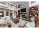 Grand great room with stone fireplace and built-in shelving at 22422 Lake Seneca Rd, Eustis, FL 32736