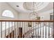 View from upper landing overlooking the grand foyer and staircase at 22422 Lake Seneca Rd, Eustis, FL 32736