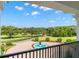 Scenic view from the balcony showcasing a fountain and sprawling grounds at 22422 Lake Seneca Rd, Eustis, FL 32736