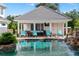 Refreshing pool with a pool house and waterfall feature at 22422 Lake Seneca Rd, Eustis, FL 32736