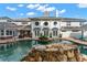 Resort-style pool with a stone waterfall and ample lounge space at 22422 Lake Seneca Rd, Eustis, FL 32736