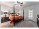 Spacious bedroom with a four-poster bed and private access at 22422 Lake Seneca Rd, Eustis, FL 32736