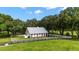 Charming one-story home with a metal roof, situated on a spacious lot at 22422 Lake Seneca Rd, Eustis, FL 32736