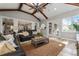 Sunroom with vaulted ceiling, leather sofas, and a view of the backyard at 22422 Lake Seneca Rd, Eustis, FL 32736