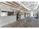 Spacious barn interior with multiple horse stalls and paved flooring at 22422 Lake Seneca Rd, Eustis, FL 32736