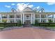 Elegant two-story home featuring a brick paver driveway and lush landscaping at 22422 Lake Seneca Rd, Eustis, FL 32736