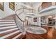 Elegant, curved wooden staircase in a two-story foyer at 22422 Lake Seneca Rd, Eustis, FL 32736