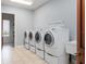 Bright laundry room with four stacked washer and dryer units at 22422 Lake Seneca Rd, Eustis, FL 32736