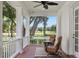 Spacious front porch with seating area overlooking a scenic landscape at 22422 Lake Seneca Rd, Eustis, FL 32736