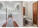 Guest bathroom with pedestal sink and hardwood floor at 22422 Lake Seneca Rd, Eustis, FL 32736
