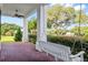 Peaceful porch swing overlooking the surrounding landscape at 22422 Lake Seneca Rd, Eustis, FL 32736