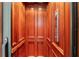 Elegant wood-paneled elevator showcasing craftsmanship at 22422 Lake Seneca Rd, Eustis, FL 32736