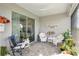 Relaxing lanai with comfortable seating and lush landscaping at 5089 Stokes Way, Wildwood, FL 34785