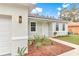 Landscaped front yard with a concrete walkway leading to the front door at 7930 Sw 127 Loop, Ocala, FL 34473