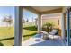 Covered patio with seating area overlooking the backyard at 3184 Evenmore Way, Wildwood, FL 34785